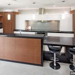 A modern kitchen with a black and timber design