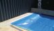 A pool covered by the clever Cleardeck pool cover from Waterblade Australia.