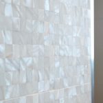 Gorgeous white bathroom with pearl tiles
