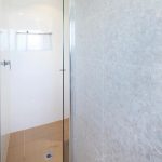 Gorgeous white bathroom with pearl tiles