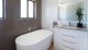 Gorgeous white bathroom with pearl tiles