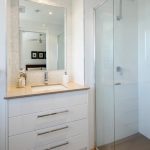 Gorgeous white bathroom with pearl tiles