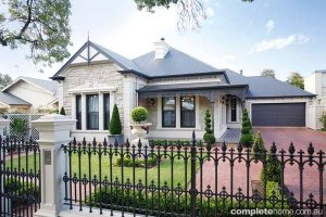 federation style home with manicured lawns and garden