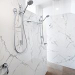 The gorgeous mosaic-tiled wall, which adds to the glamorous appeal of the bathroom.