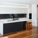 This black and white kitchen is both bold and attractive - incorporating natural elements such as timber to make it light and homely.