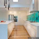 We love the acrylic couture malachite green splashbacks, which add intense colour and drama to the open kitchen.