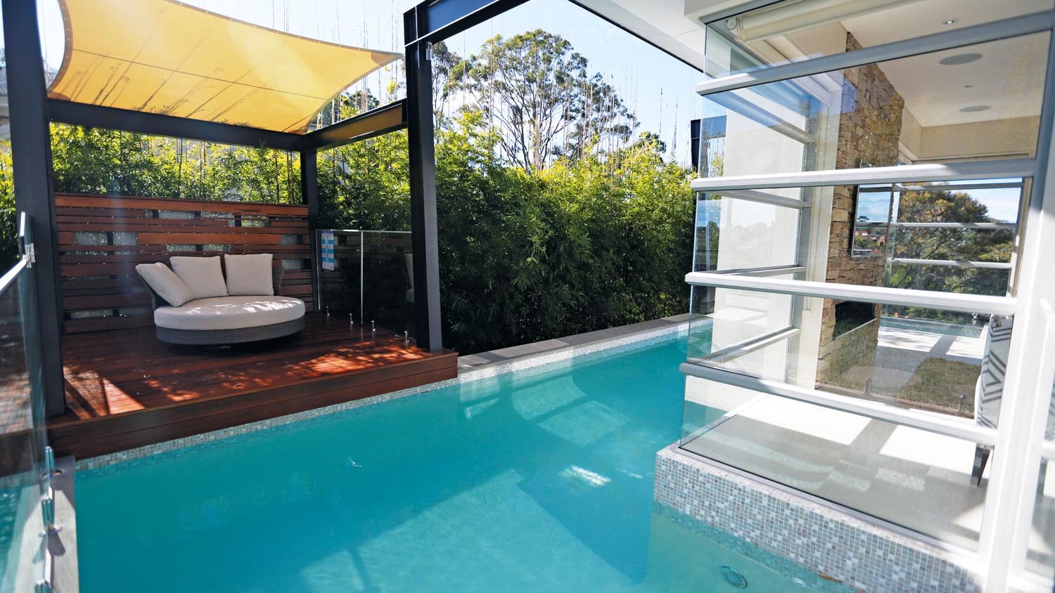 This pool wraps closely around the contemporary house, creating a perfect resort look