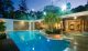 An opulent swimming pool and lavish landscape offers privacy and year-round luxury
