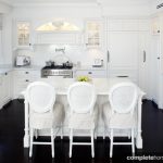 Contrasting white cabinetry against deep chocolate flooring, this federation-style kitchen is complimented by every detail