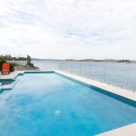 This pool design perfectly complements the surrounding houses.