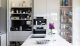 A white modern kitchen with a tap and flowers
