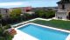 A modern pool next to buildings and a view of the city