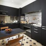 An all-black kitchen with a steel splashback is the perfect mix of practicality and style