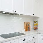 The clean cabinetry in this kitchen creates storage space and a beautiful effect