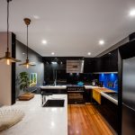 A kitchen with butcher’s block, deep fryer and chargrill plate