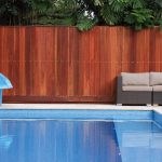Modern pool with outdoor furniture and a water slide