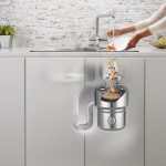 A view of a person washing food down the drain and how it gets disposed of.