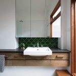 Green fish scale tiles bring a natural aspect to the bathroom