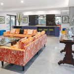 Bright colours are mixed with rich timber and a touch of metallic in the living room
