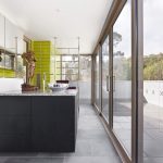 Glass doors ensure natural light fills the bathroom
