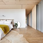 With so much warmth created by the floorboards, simple is best in the bedroom