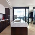 A generous kitchen calls on luxe materials to create a stunning space