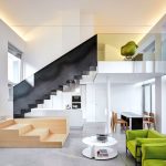 A feature staircase separates the different functions of the open-plan space