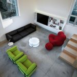 Bright furniture pieces bring colour and energy into the neutral space