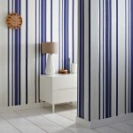 Expand a small space or create the illusion of high ceilings with the Hoppen Stripe wallpaper in white and Prussian blue from GRAHAM & BROWN. The white stripes are textured with a linen effect while a subtle silver strip lines either side, making it pop. grahambrown.com/uk