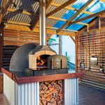 An oven from The Melbourne Fire Brick Company is the focal point of this outdoor kitchen.