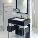 The smooth lines of a Corian Serenity basin installed within a frame of steel and Corian Deep Nocturne create a sophisticated impression. With atmospheric lighting, it becomes the statement centrepiece for a hotel suite or penthouse.