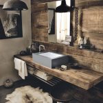 Smoothly set into Corian in the industrial grey Deep Cloud shade, the Corian Refresh washbasin offers a touch of contemporary chic to the wooden vanity top’s rough texture, providing an unexpected twist to a rustic ambience.