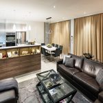 The kitchen and dining areas are both stylish and well-lit thanks to the use of pendant lights