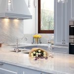 This compact kitchen design makes up for space by incorporating cupboards and drawers within a U-shaped bench