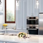 This compact kitchen design makes up for space by incorporating cupboards and drawers within a U-shaped bench