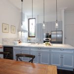 This compact kitchen design makes up for space by incorporating cupboards and drawers within a U-shaped bench