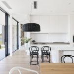 Based around the concept of three distinct living areas, two barns are connected by a glass pavilion, enabling the two timber-clad structures to hold their own and take advantage of the view