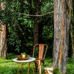 Splice table and chair in bronze  and Uashmama metallic bag in Rose. lifeinteriors.com.au Gava planter (pair), Gava antique  silver dish, Gava copper-plated dish  and antique brass oval platter. cittadesign.com