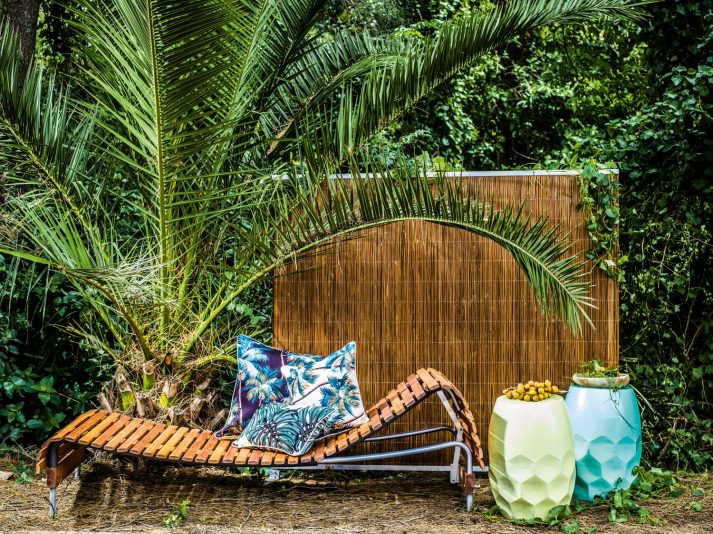 Adjustable day bed  and multi-function screen  in Natural. Designed  by Mark Snyders.  houseofbamboo.com.au Hex tables in Minty  Powder Blue and Pale Yellow, Oasis outdoor cushion in Palm Trees  and South Pacific.  escapetoparadise.com.au