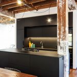 An all-black kitchen that combines industrial style and modern finesse