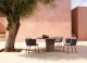 Tao round table in lightened concrete sits elegantly with the Tosca outdoor dining chairs by Tribu.