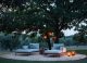 the Monsieur Tricot pendants are hung from a tree to make the sofa setting look inviting