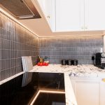the black and white benchtop blends well with black appliances