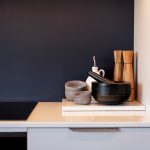 A close up detail shot of kitchen decor showcasing bowls and a choppping board