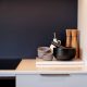 A close up detail shot of kitchen decor showcasing bowls and a choppping board
