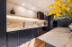 marble and black themed kitchen with yellow flowers