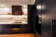 Kitchen with Black storage and marble backsplash