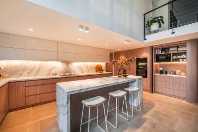 A white modern kitchen with a tap and flowers