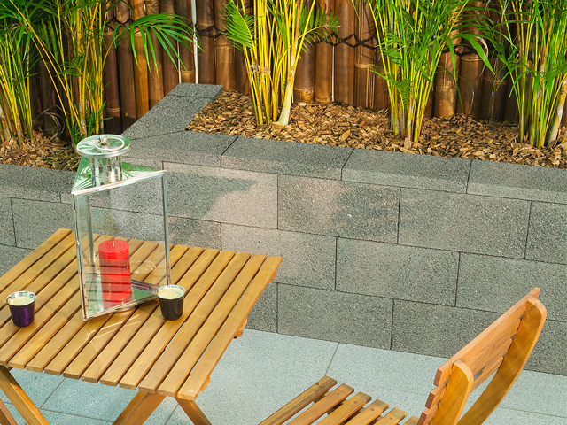 A Versastone retaining wall system is perfect for a poolside summer