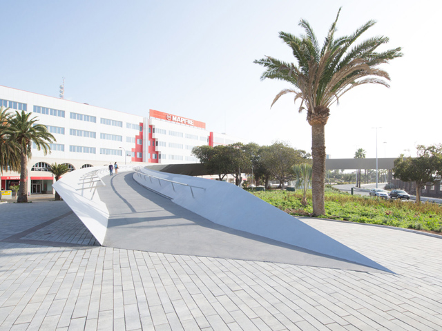 Footbridge Curves Above Spanish Waterfront